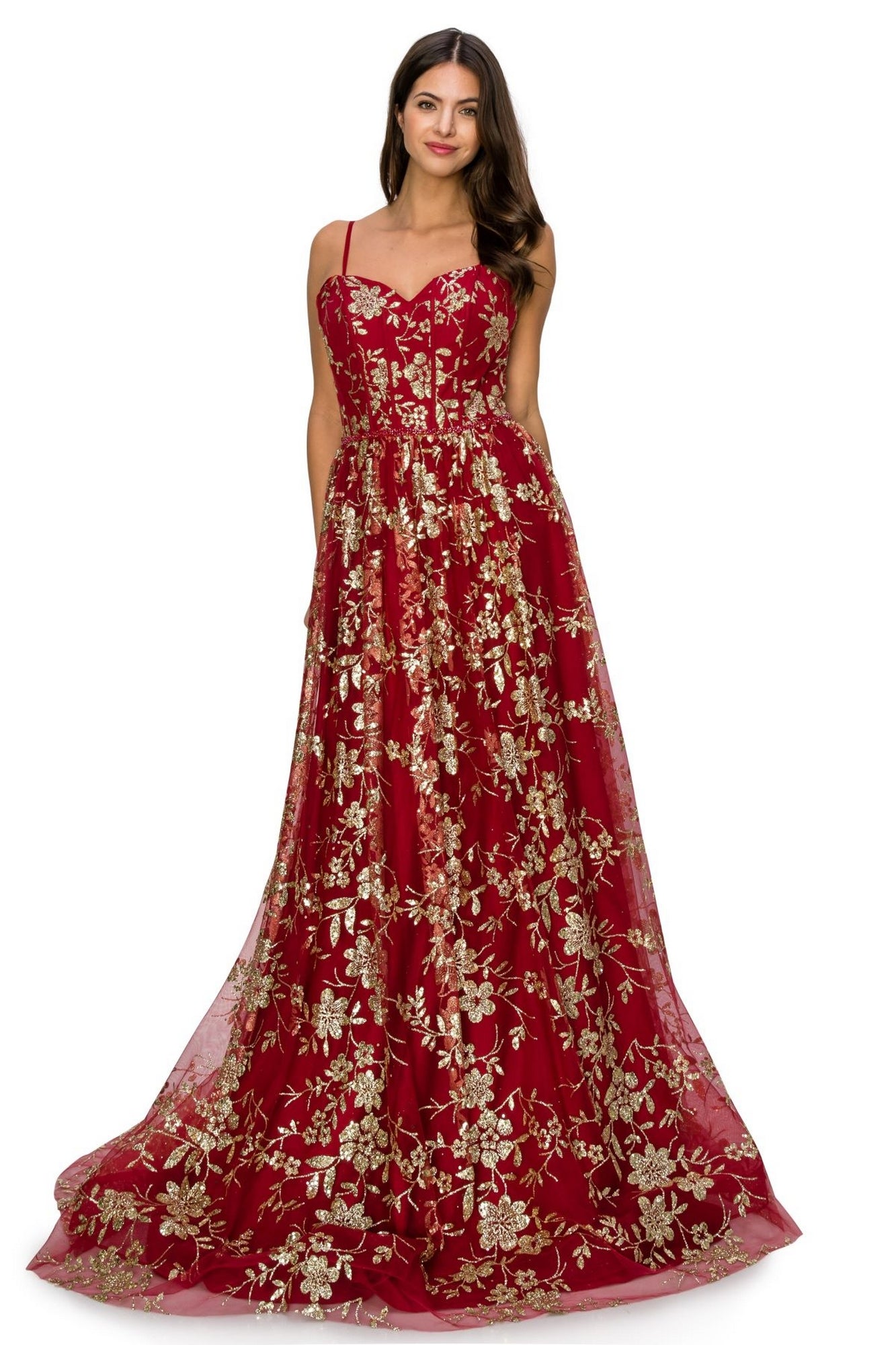A woman stands wearing the Glitter-Floral Long Strapless Prom Dress 8043J, a floor-length red gown with gold glitter floral print and a fitted bodice.